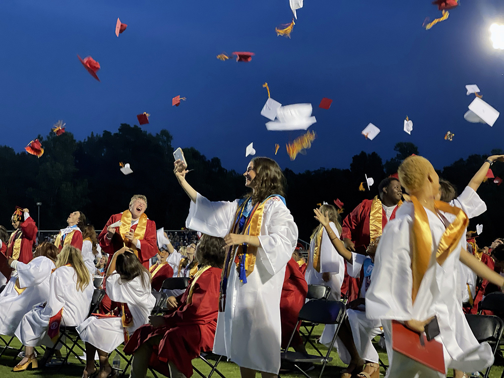 Goochland High School graduates throwing their caps in the air