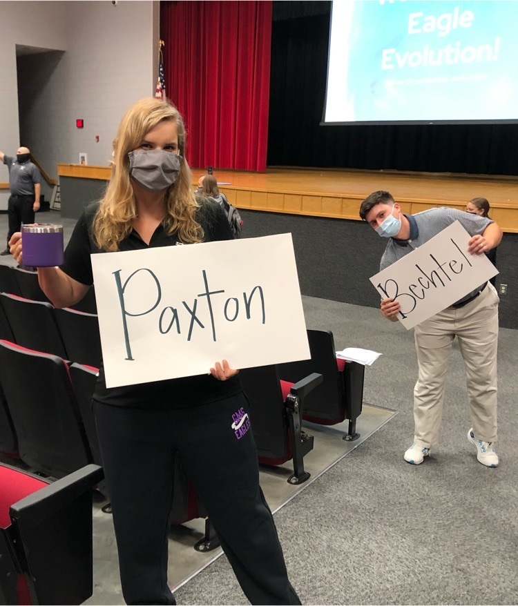 teachers welcome students in auditorium