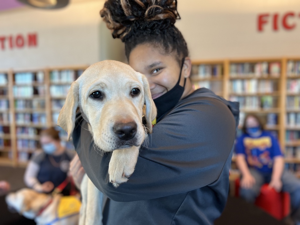 Student holding dog