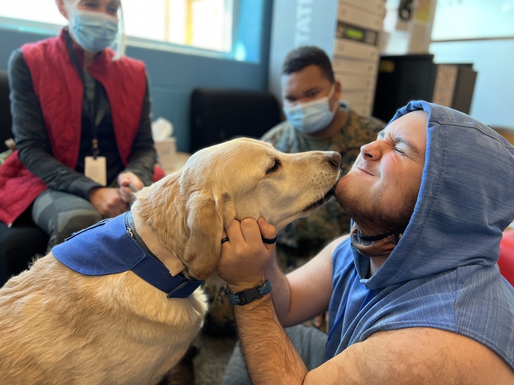 Student kissing dog